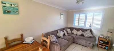 a living room with a couch and a table at Ocean's Eddge, Perranporth in Perranporth