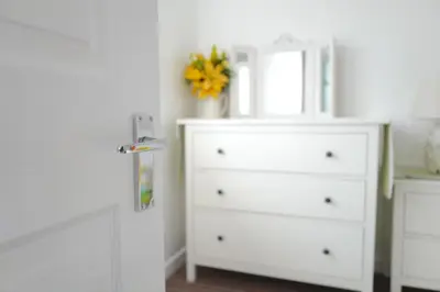 a white dresser with a mirror and a white dresser at Krissie's in Marazion