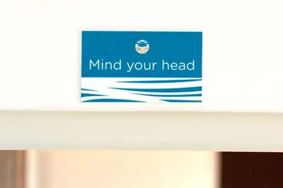 a sign on top of a counter with water at Oasis Apartment in Falmouth