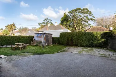 a backyard with a picnic table and a fence at Oasis Apartment in Falmouth