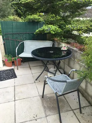 a table and two chairs sitting on a patio at Down Ende House Accommodation in Looe