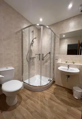 a bathroom with a shower and a toilet and a sink at Eliot Hotel in Newquay