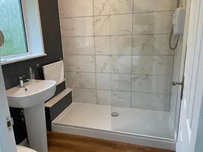 a bathroom with a shower and a sink at The Mandalay Guest House in Mevagissey