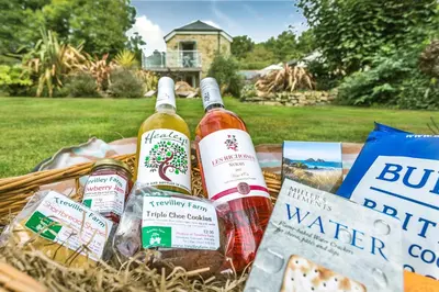 a picnic basket with bottles of wine and bread at Pear Tree Barn - Amazing Country views - Pet friendly - Balcony in Newquay