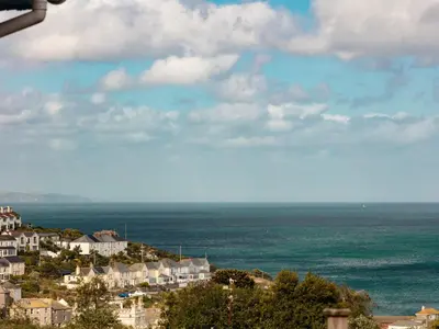 a group of houses on a hill next to the ocean at Nectan in St Austell