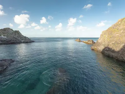 a large body of water with rocks in it at Nectan in St Austell