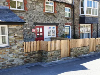 a wooden fence in front of a house at Beach Hut in Tintagel