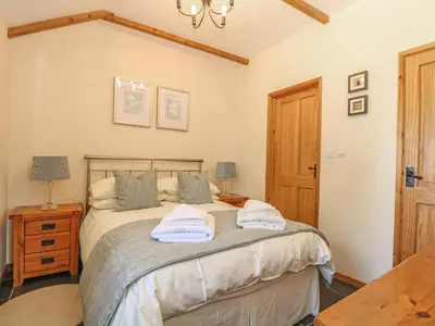 a bedroom with a bed with towels on it at Beech Cottage in Truro
