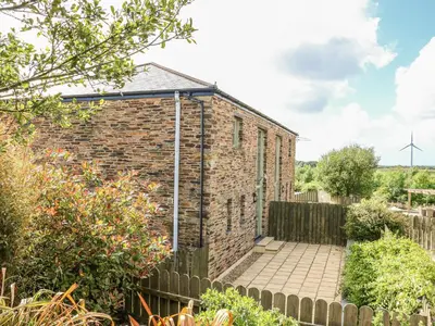 an old brick building with a solarium on top at Hawthorn Cottage in Truro