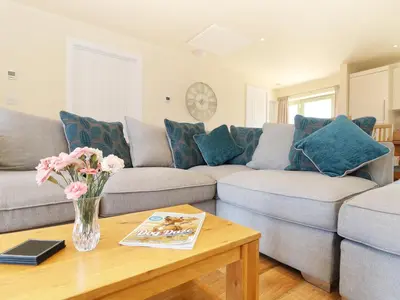 a living room with a couch and a table at Elm Cottage in Truro