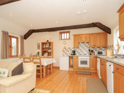 a kitchen and living room with a couch and a table at Swallows Nest in Launceston