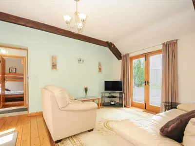 a living room with a couch and a tv at Swallows Nest in Launceston