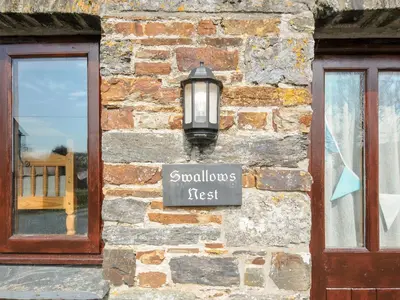 a street light on the side of a brick building at Swallows Nest in Launceston