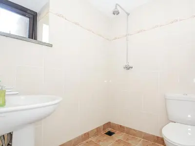 a white bathroom with a sink and a toilet at Barn Owl Cottage in Launceston