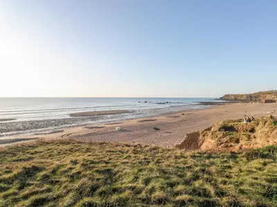 a view of a beach with the ocean in the background at Barn Owl Cottage in Launceston