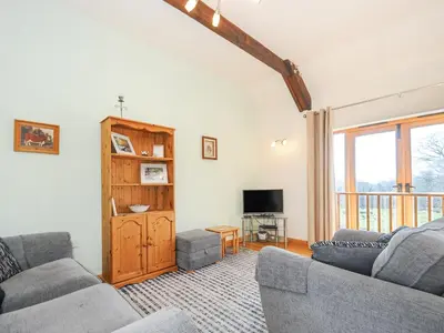 a living room with two couches and a television at Barn Owl Cottage in Launceston