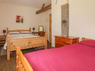 a bedroom with a bed and a dresser and a bed sidx sidx sidx sidx at Garras Barn in Truro