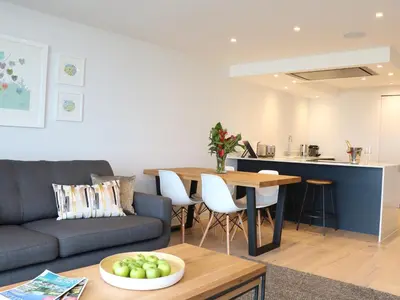 a living room with a couch and a table at Little Fistral in Newquay