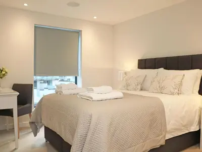 a bedroom with a large bed with towels on it at Little Fistral in Newquay