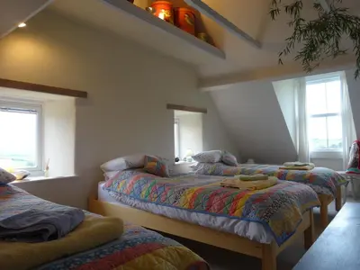 a bedroom with three beds in a room at Heatherdale in Tintagel