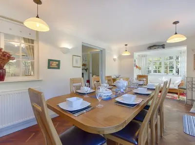 a dining room with a wooden table and chairs at Orchard Lodge in Boscastle