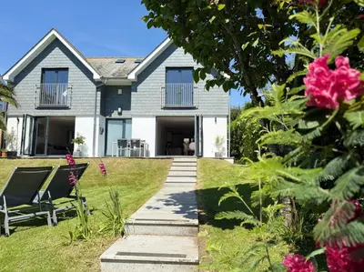 a house with two chairs in the yard at No.10 Falmouth - 2 minutes walk to the beach in Falmouth