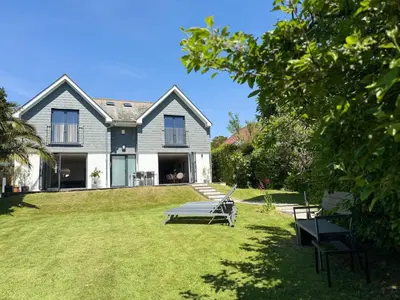 a house with a yard with a table and a bench at No.10 Falmouth - 2 minutes walk to the beach in Falmouth