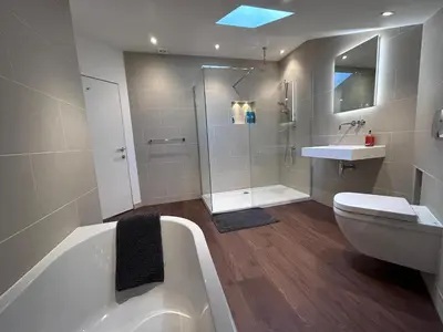 a bathroom with a tub and a toilet and a sink at No.10 Falmouth - 2 minutes walk to the beach in Falmouth