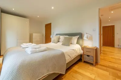 a bedroom with a bed with towels on it at Amaroo in St. Agnes