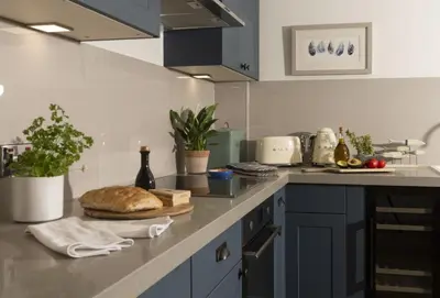 a kitchen with a counter with a loaf of bread on it at Cob Cottage in St. Agnes
