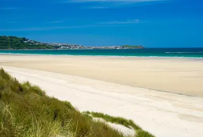 a sandy beach with the ocean in the background at Copperhouse View in Hayle