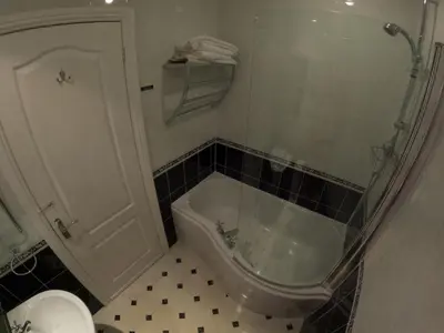 a bathroom with a tub and a toilet and a sink at The Grove Falmouth in Falmouth