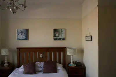 a bedroom with a bed and two pictures on the wall at The Grove Falmouth in Falmouth