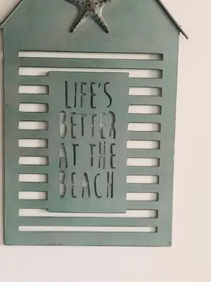 a sign that reads lifes better at the beach at Bay House Lundy Port Isaac Apartment with Sea Views & Parking in Port Isaac
