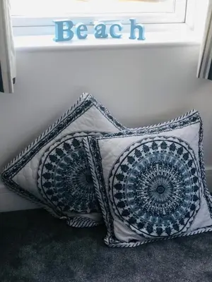 a pair of pillows sitting next to a window at Bay House Lundy Port Isaac Apartment with Sea Views & Parking in Port Isaac