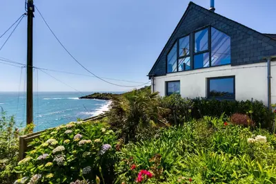a house with a view of the ocean at Dolphins in Coverack
