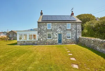 an old stone house with a large yard at Balwest Cottage in Helston