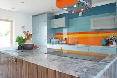 a colorful kitchen with a counter top and a sink at Skysail - Exceptional Sea Views in Mevagissey