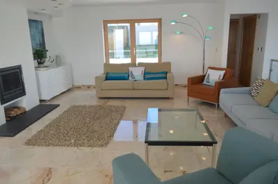 a living room with couches and a coffee table at Skysail - Exceptional Sea Views in Mevagissey