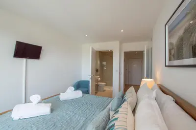 a bedroom with a large bed with two pillows at Harbour Lights in Newquay