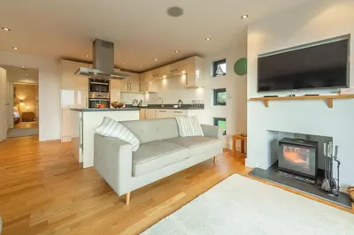 a living room with a couch and a fireplace at Morvah in St. Agnes