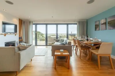 a living room with a table and a dining room at Morvah in St. Agnes