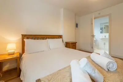 a bedroom with a bed with towels on it at Porthia in Hayle