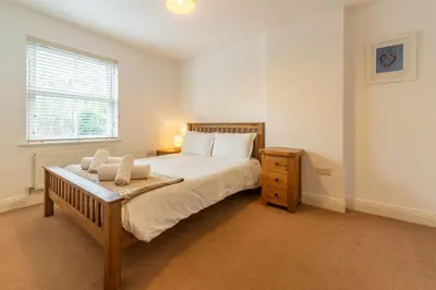 a bedroom with a large bed and a window at Porthia in Hayle