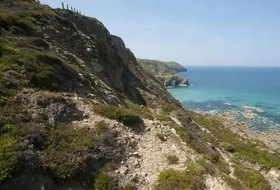 a view of the ocean from the side of a mountain at Scrumbles Hollow in St. Agnes