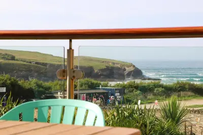 a view of the ocean from a table and chairs at Beachside apartment, sea views in St Merryn