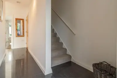 a staircase in a home with white walls at Sea Folly in Perranporth