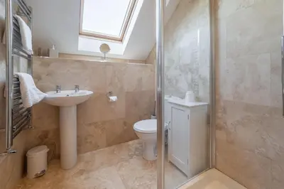 a bathroom with a toilet and a sink and a shower at Sea Folly in Perranporth