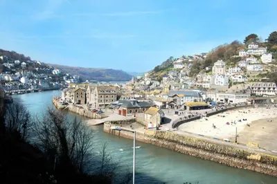 a town on a hill next to a river at Millendreath at Westcliff - Self Catering flat with amazing sea views in Looe
