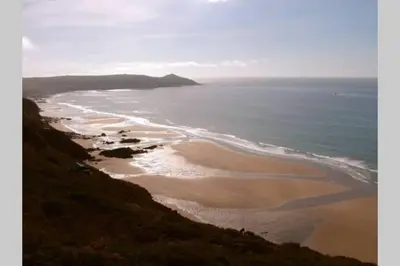 an aerial view of a beach and the ocean at Millendreath at Westcliff - Self Catering flat with amazing sea views in Looe